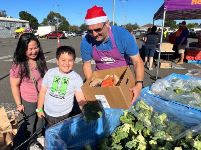 Cecilia and her son at a Foodbank market