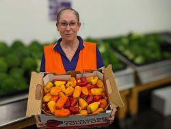Tanya with Donated Capsicums Fridge Chiller Warehouse