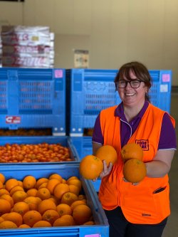 Angela holding fresh produce